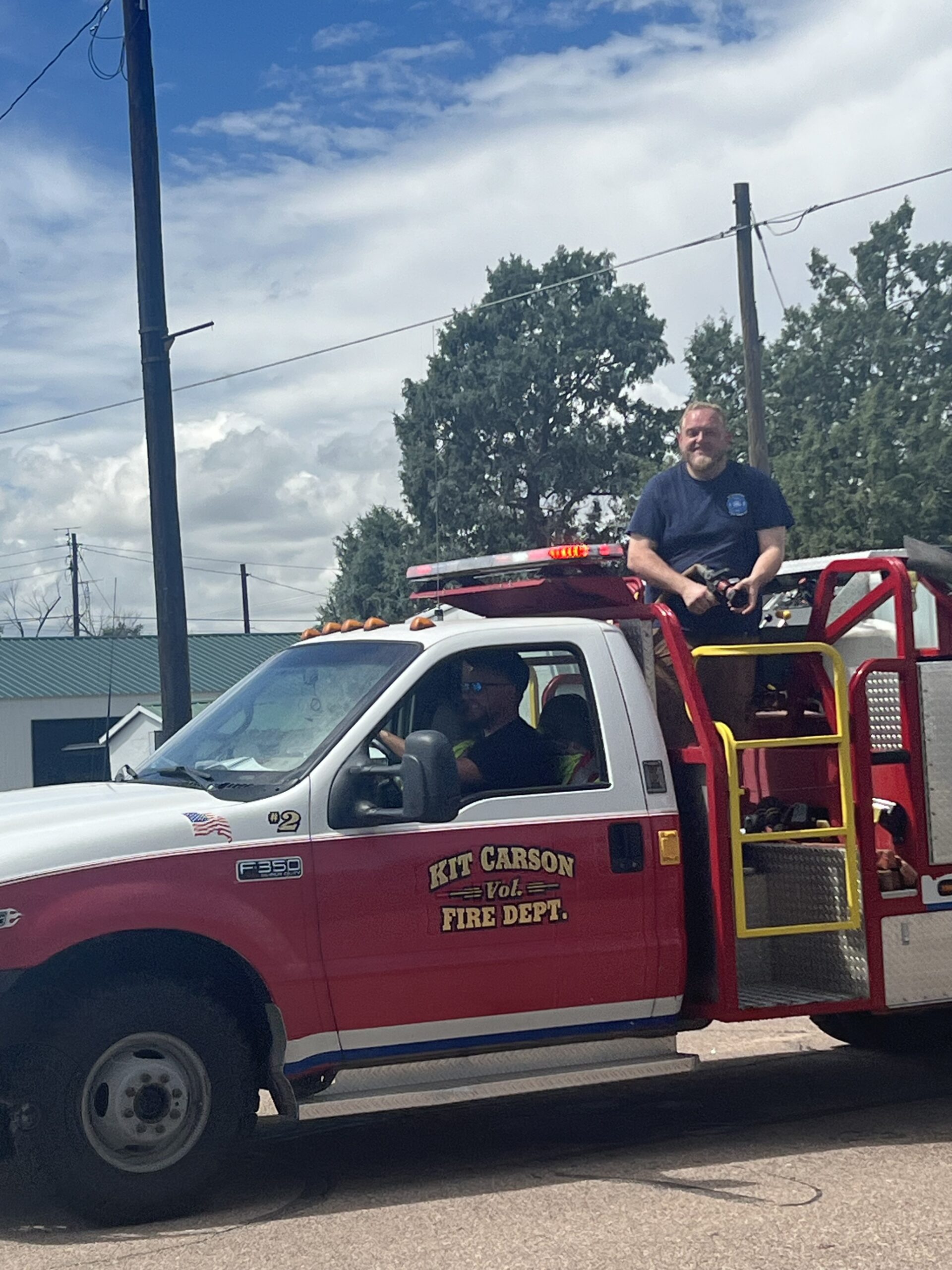 John Mitchek sitting on a fire truck in Kit Carson, Colorado.